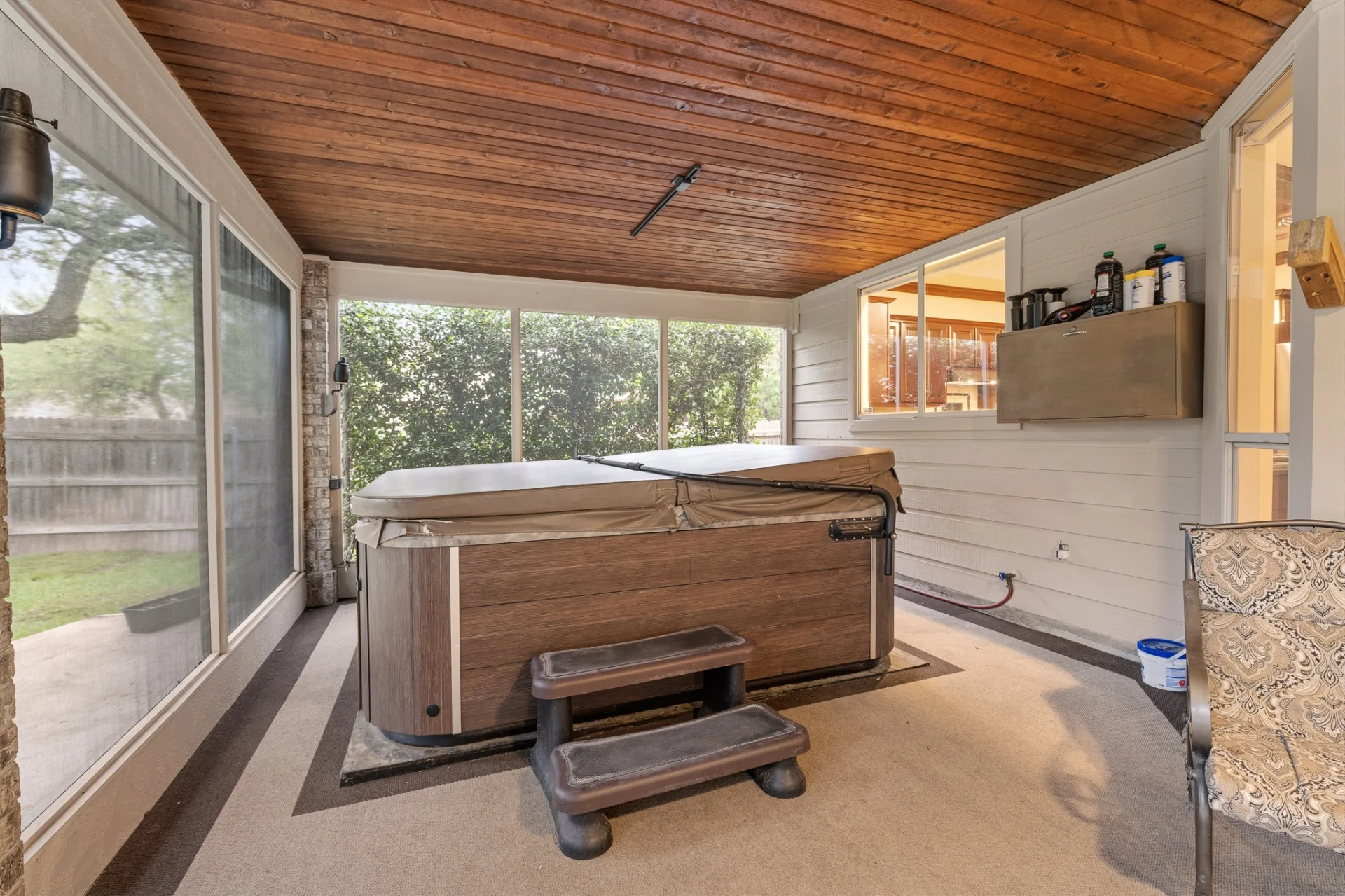 Hot tub on the screened patio under cedar ceiling