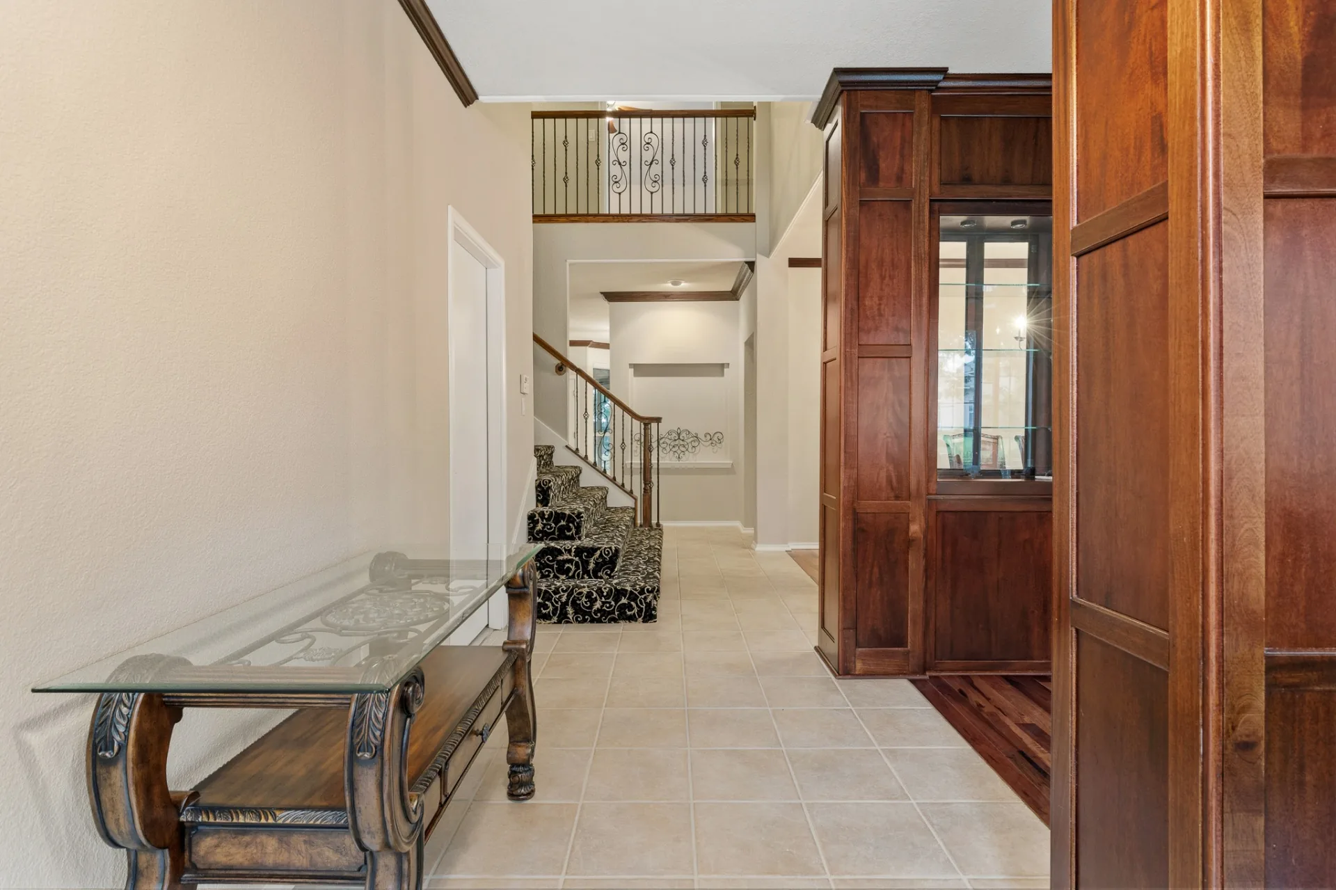 Entry foyer with staircase and wrought iron railing