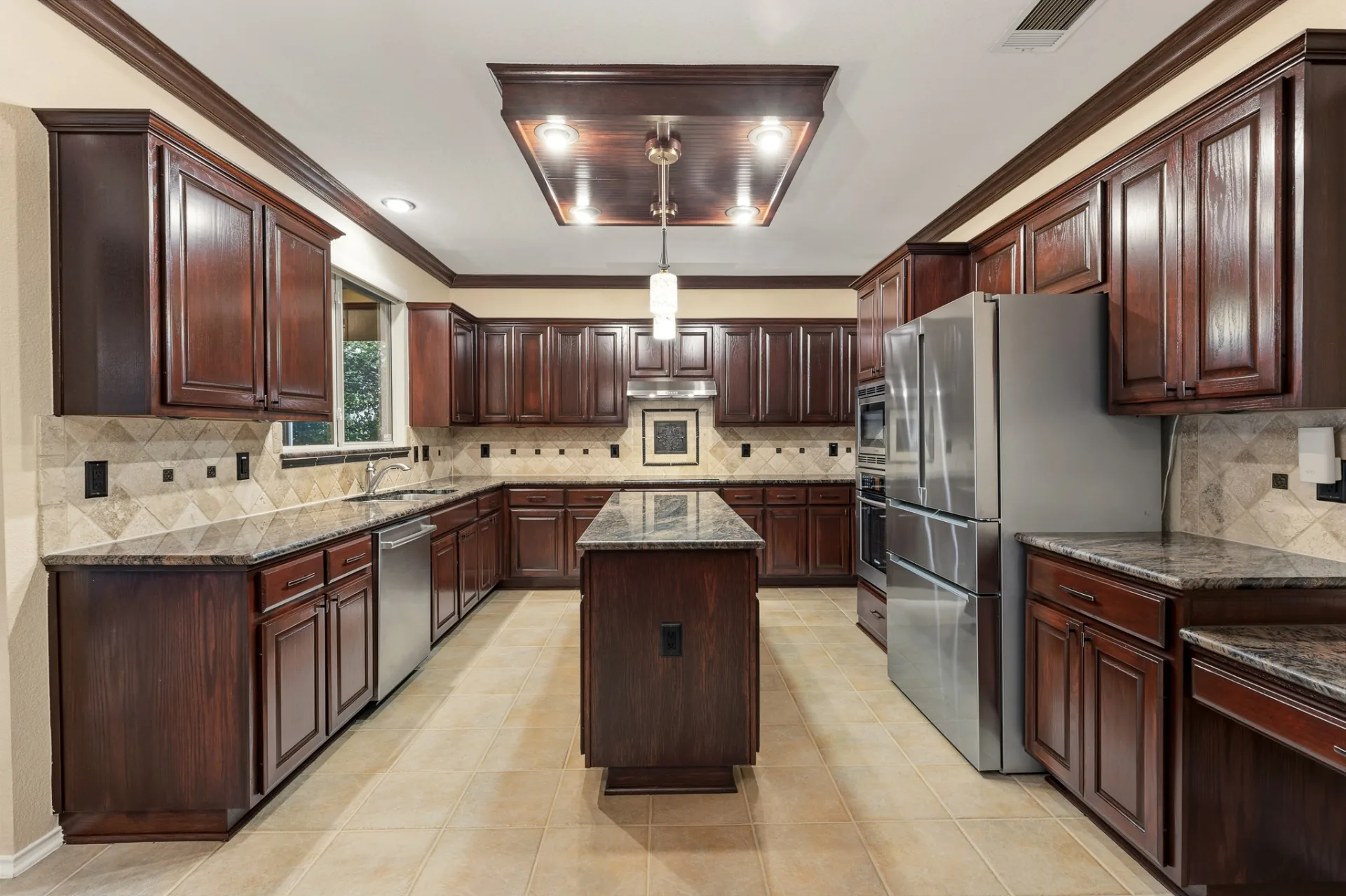 Kitchen with center island, custom cabinetry, and granite counters