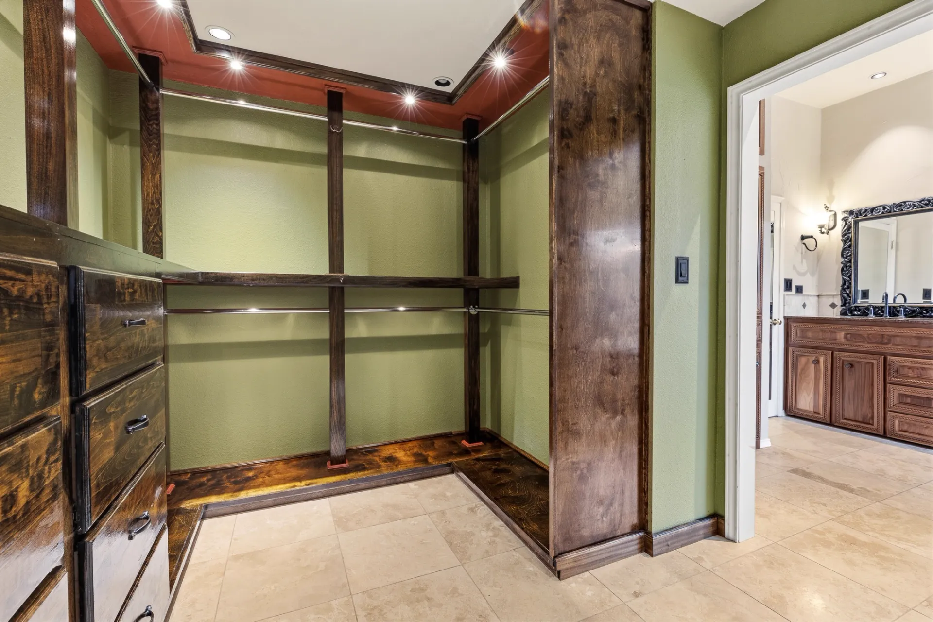 Primary walk-in closet with custom built-ins and lighted shelving