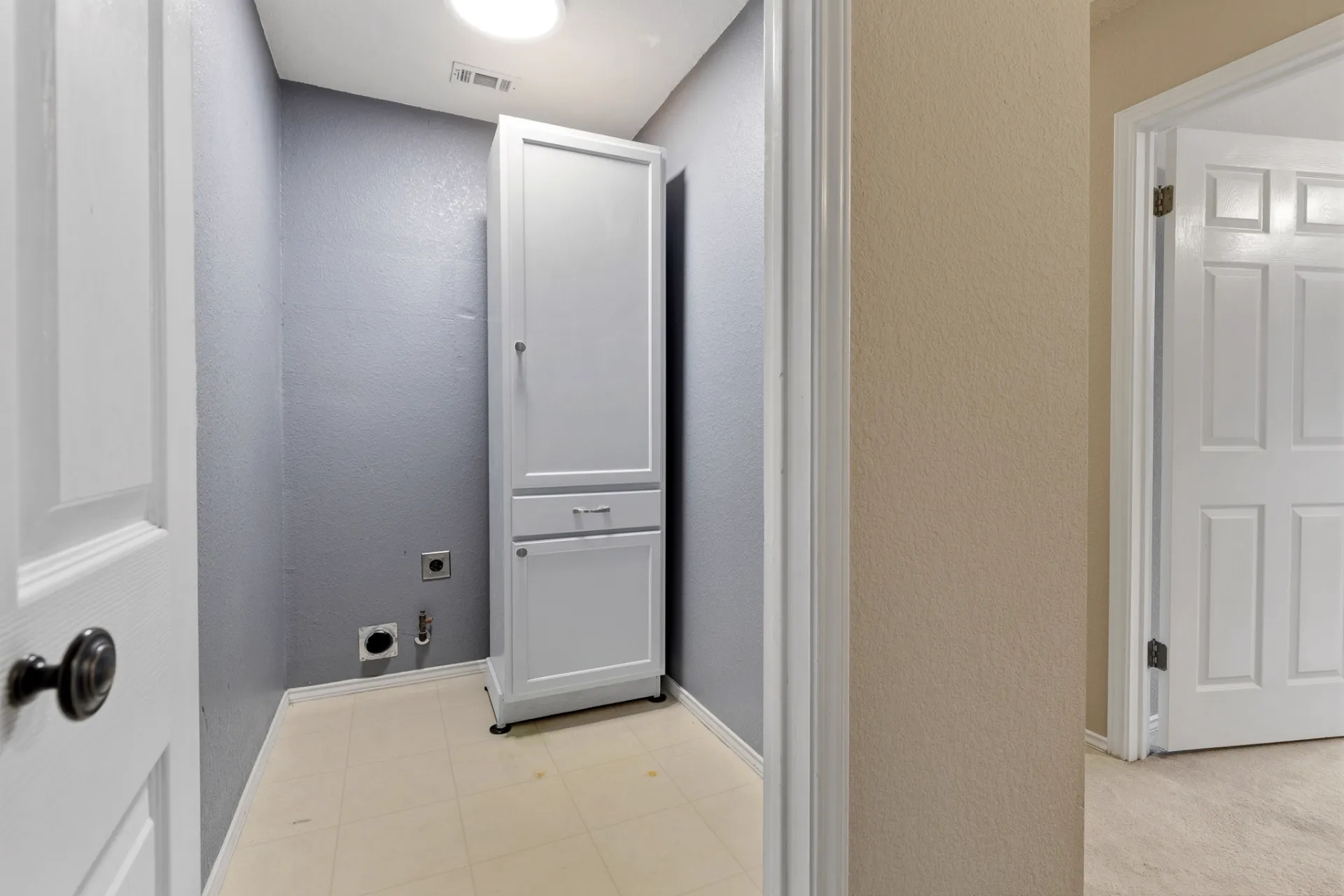 Laundry room with built-in storage cabinet